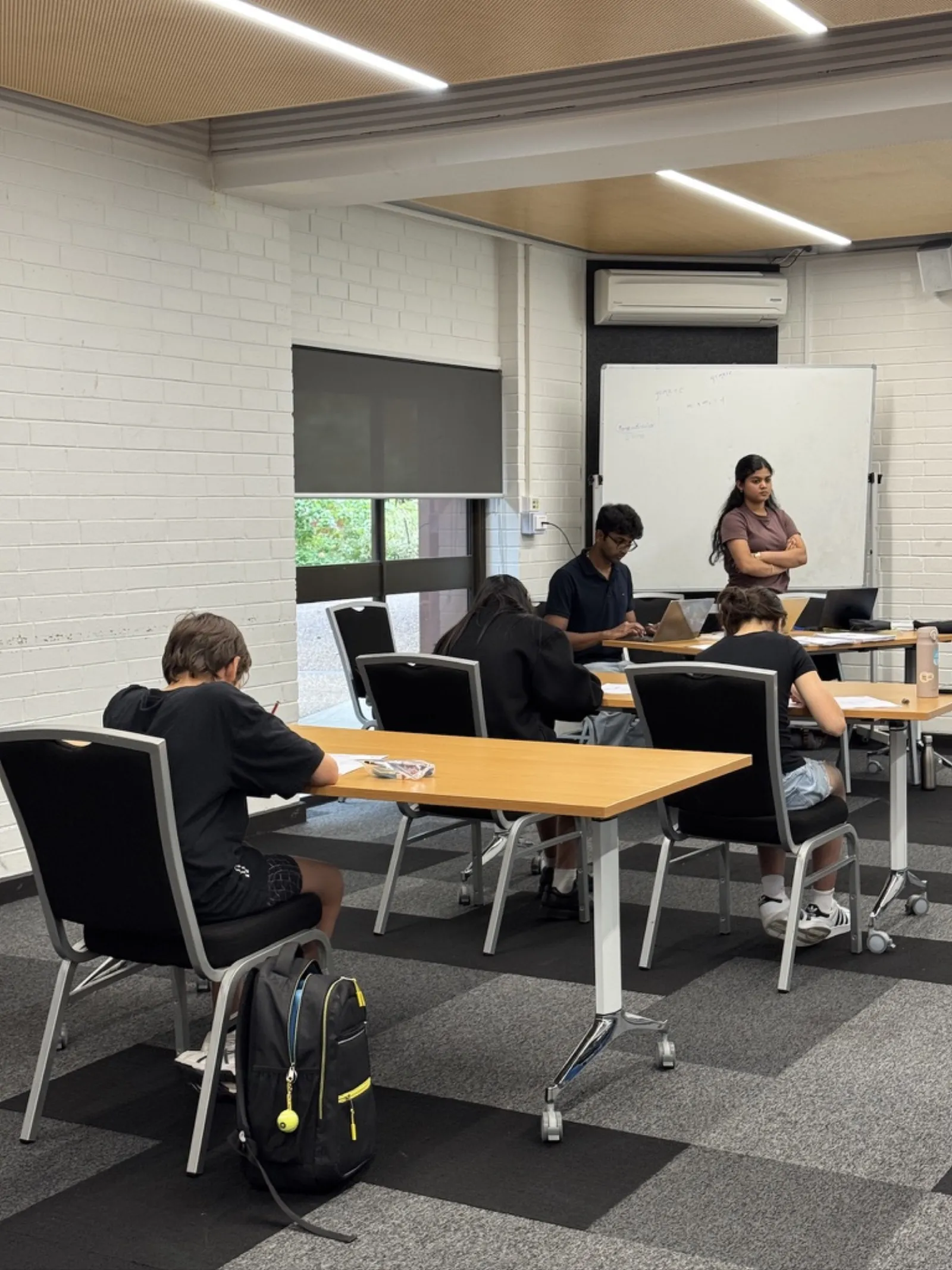 An EduVerse tutor working through a problem with students