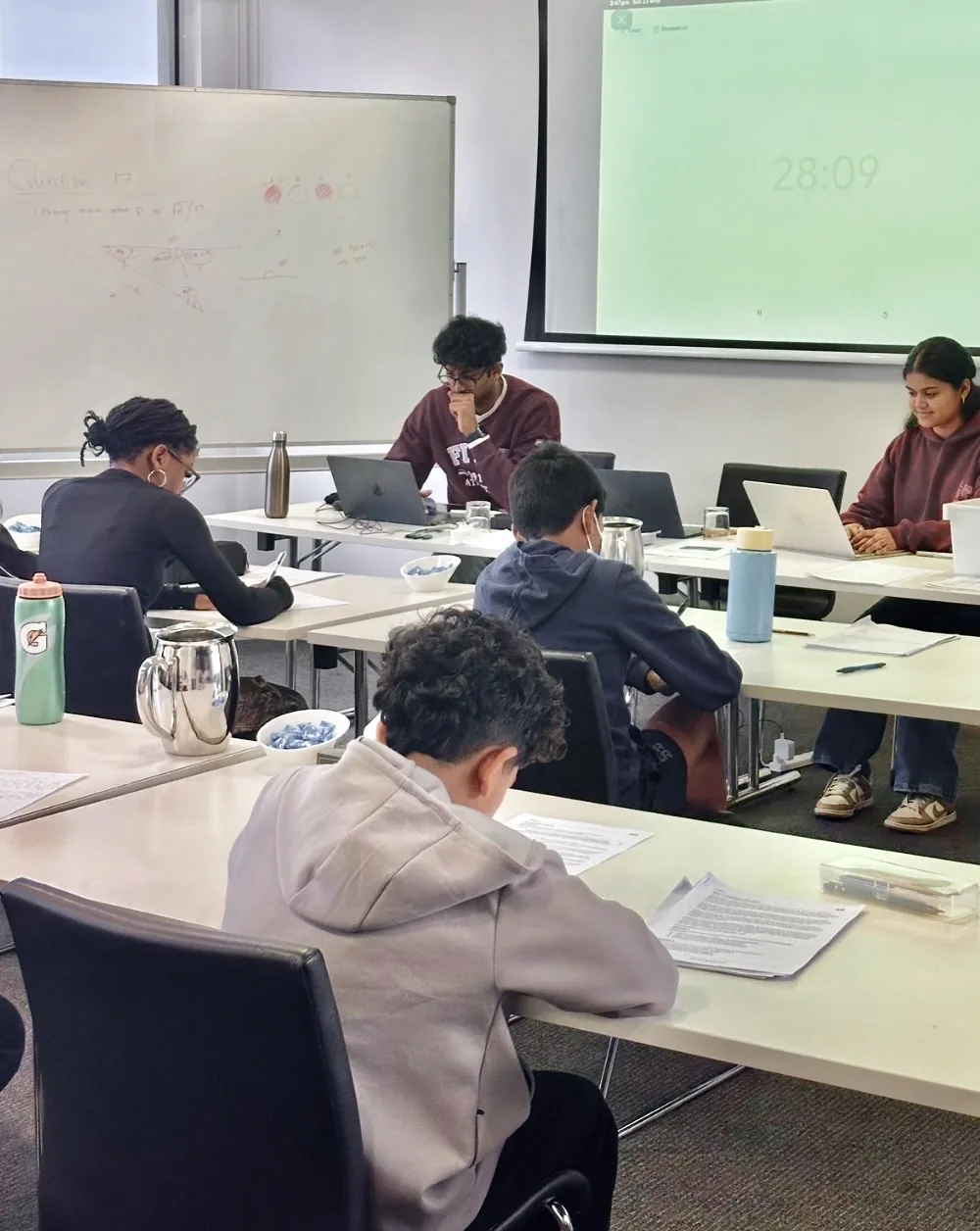 A tutor working through an exam question with a student